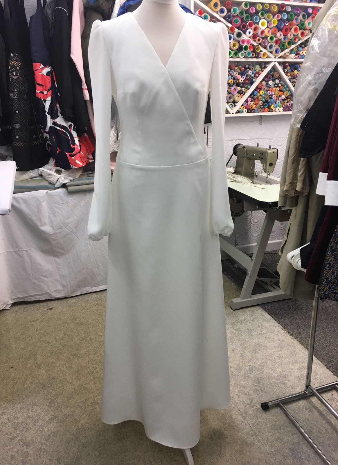 Elegant minimalist white wrap dress with long sleeves