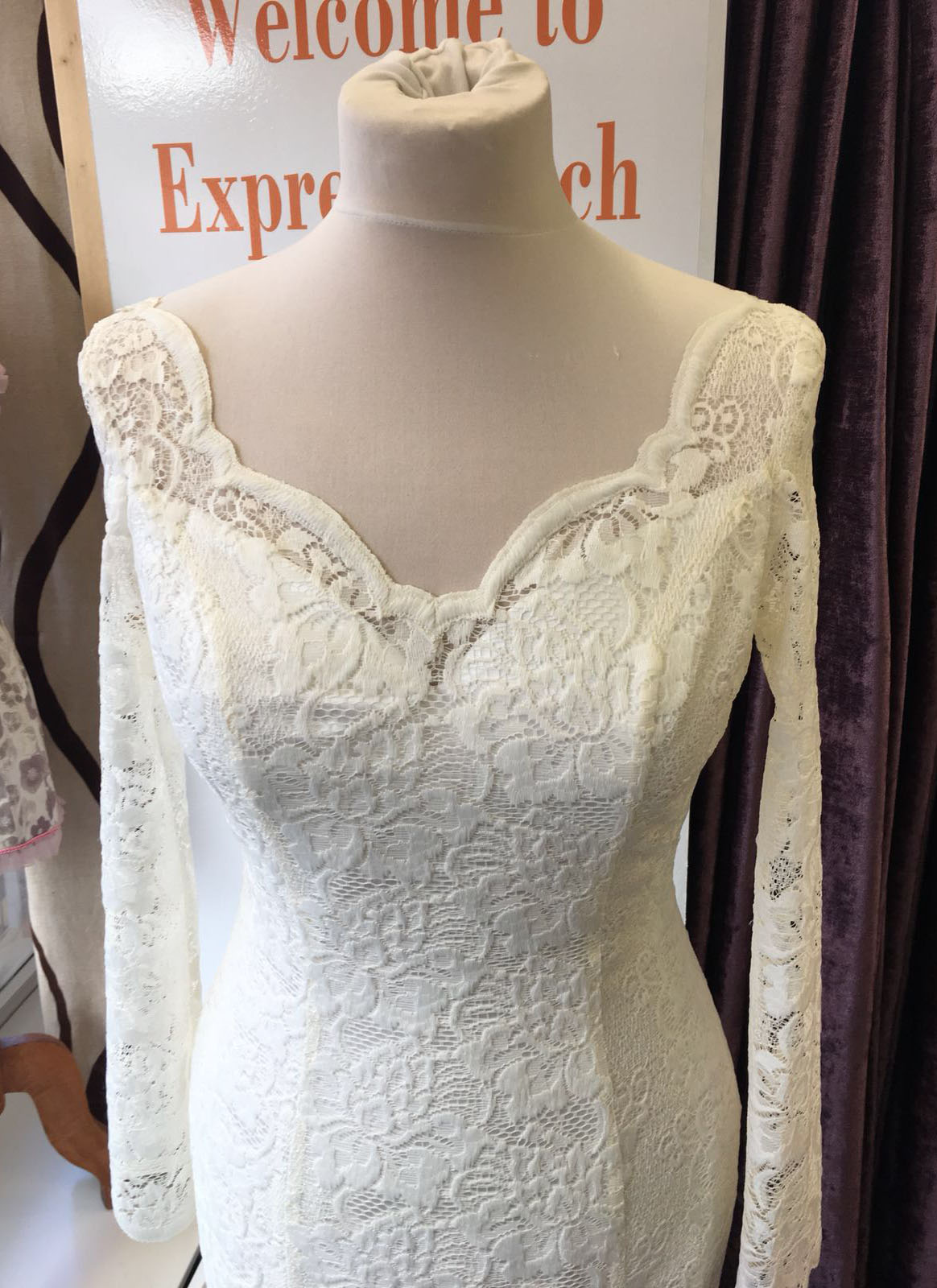 White lace wedding dress with sweetheart neckline and long sleeves