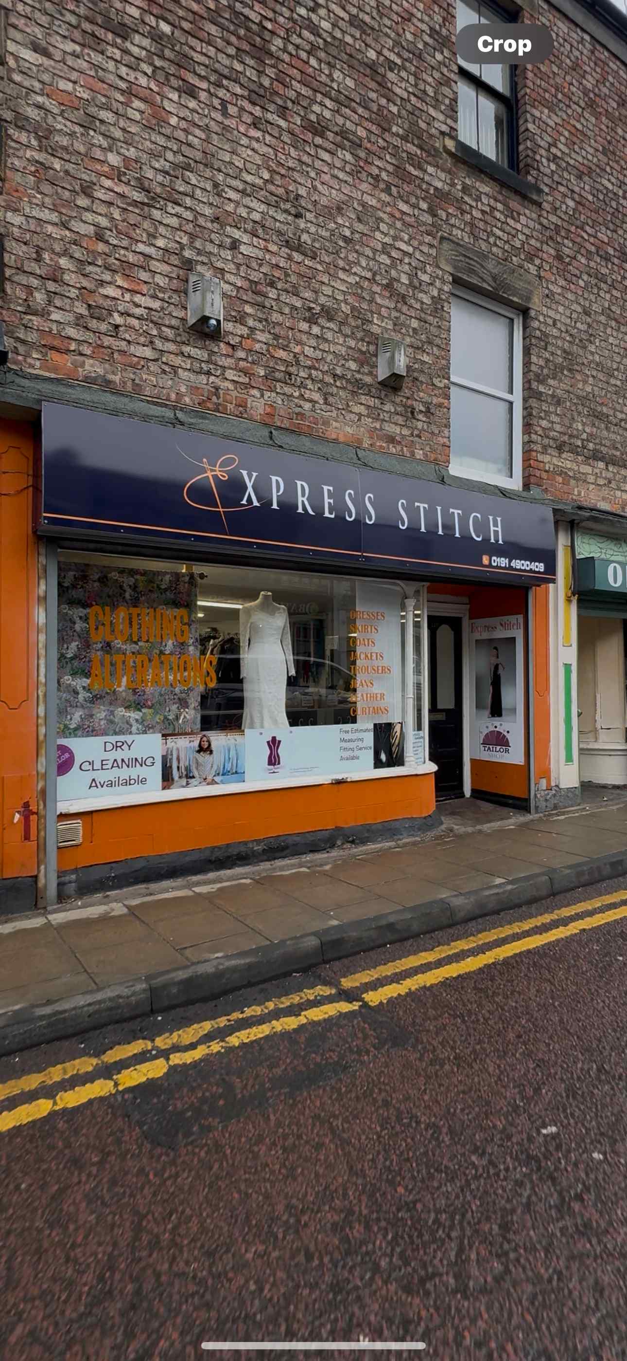 Express Stitch tailoring shopfront on Coatsworth Road, Bensham, Gateshead - showing the navy blue storefront sign with orange logo, window display with mannequin wearing white dress, and Clothing Alterations signage
